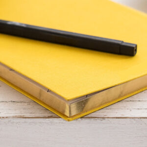 Yellow notebook and pen